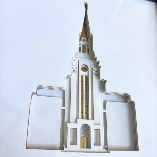 A cutout architectural model of a temple spire, likely a LDS Church temple replica, shown against a plain white background.