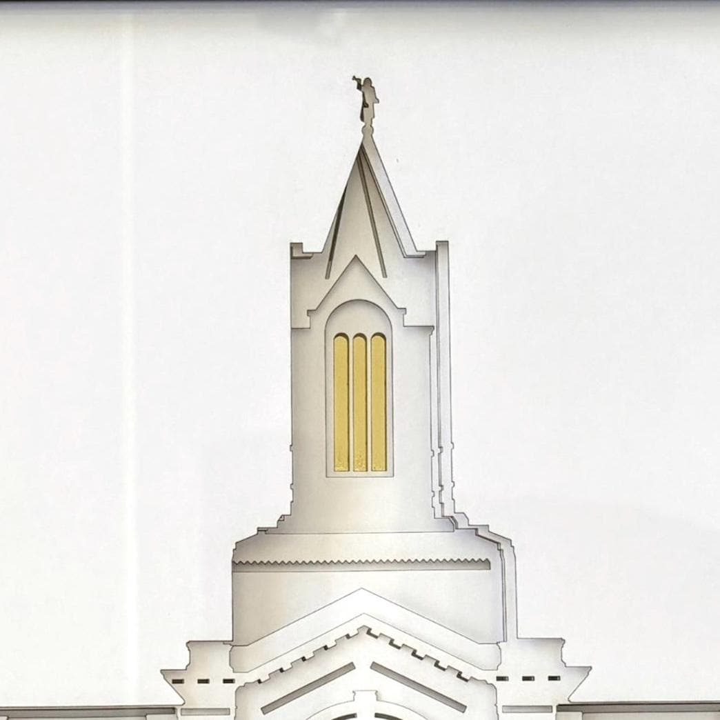 A close-up architectural rendering of a white church tower or spire with a small gold window and a small cross at the top, shown against a white background. Fort Collins Temple Art Gift