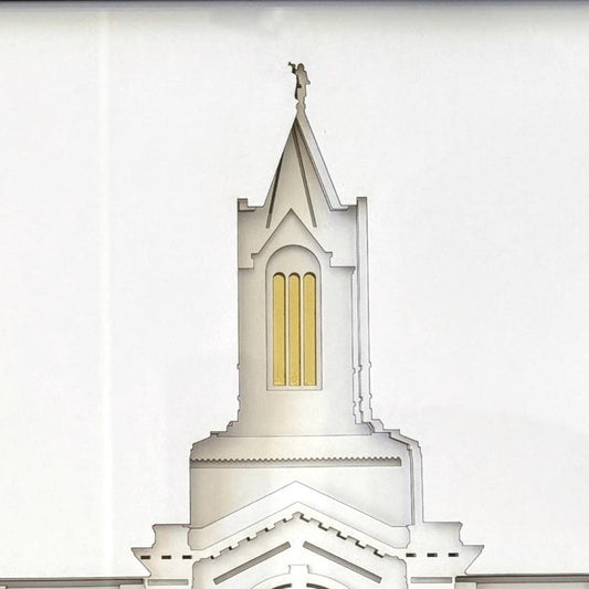 A close-up architectural rendering of a white church tower or spire with a small gold window and a small cross at the top, shown against a white background. Fort Collins Temple Art Gift
