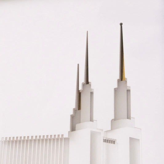 A DC Temple Gift - minimalist architectural photograph of a white temple-like building with two tall spires against a very light gray or off-white sky.